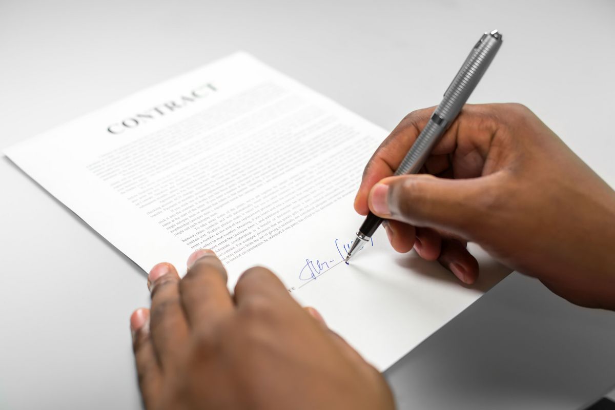 Eine Person unterzeichnet einen Vertrag, Foto: Colourbox
